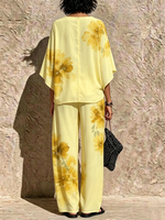 Two-piece Set Featuring A Loose, Batwing-sleeve Top With A Watercolor Floral Print And Wide-leg Trousers
